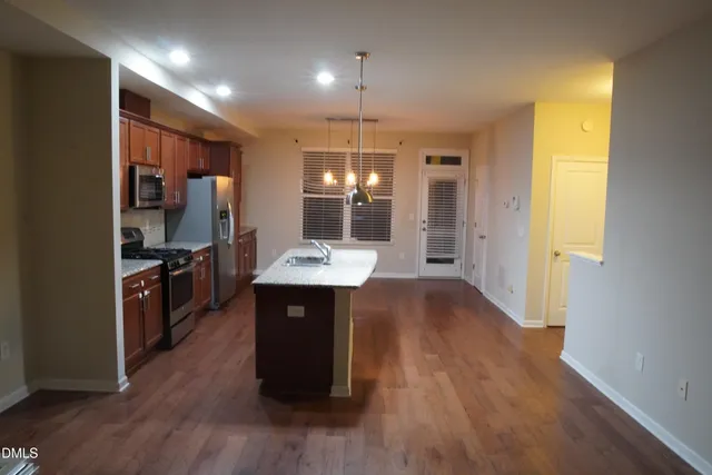 a kitchen with granite countertop stainless steel appliances and cabinets