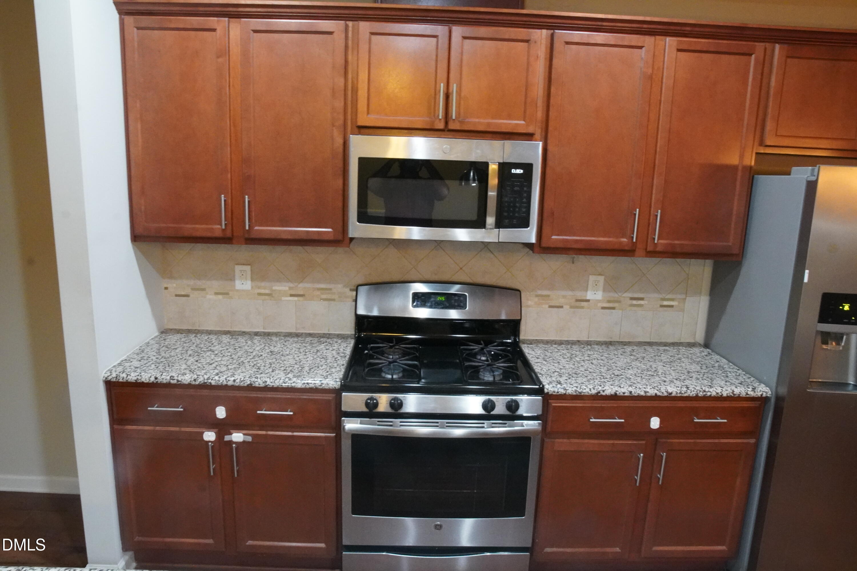 4039 Sykes Street Cary, NC 27519 - Photo 5 of 22 a kitchen with granite countertop stainless steel appliances and cabinets