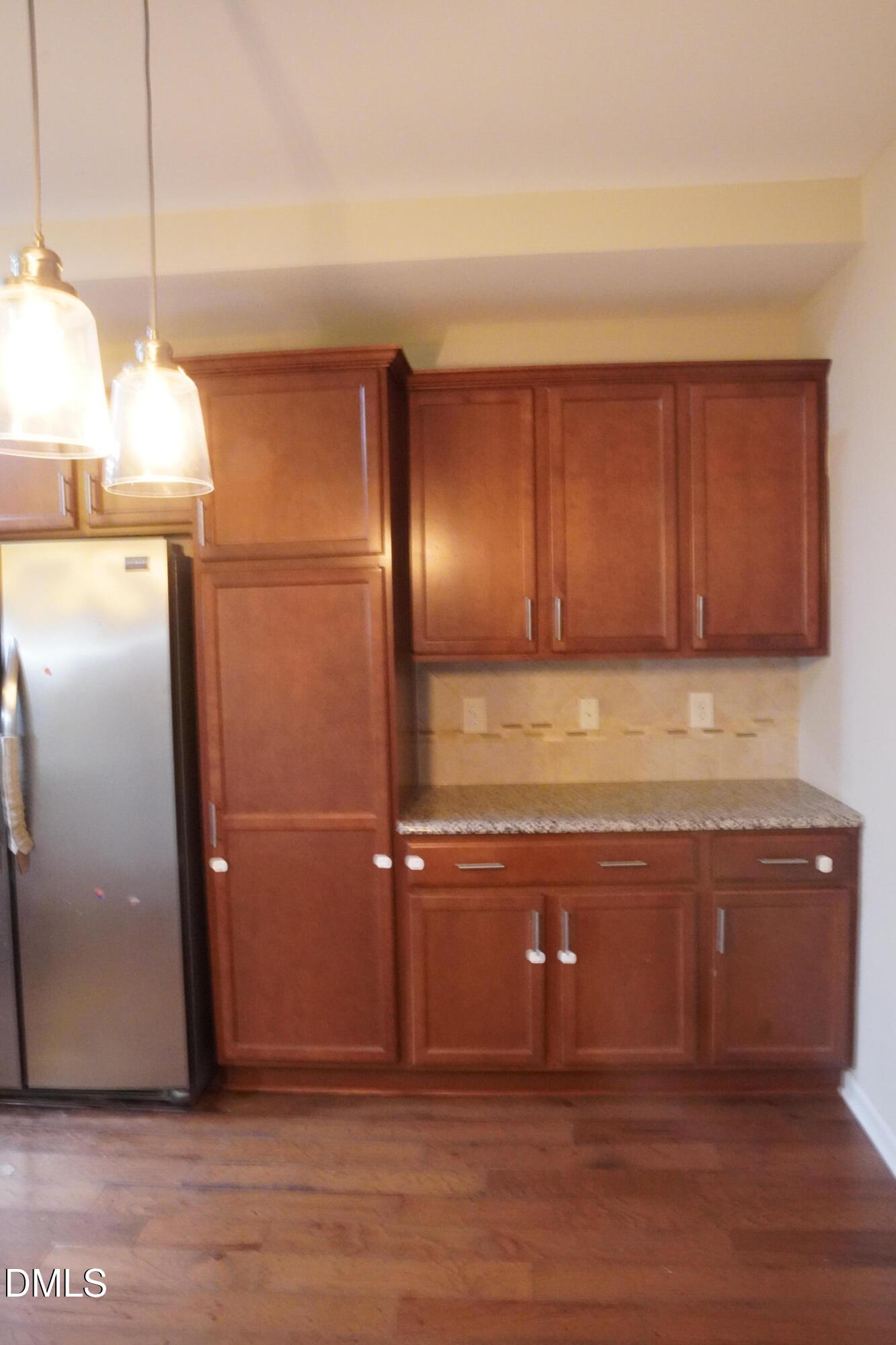 4039 Sykes Street Cary, NC 27519 - Photo 8 of 22 a view of a refrigerator in kitchen with stainless steel appliances wooden cabinets and a counter top space