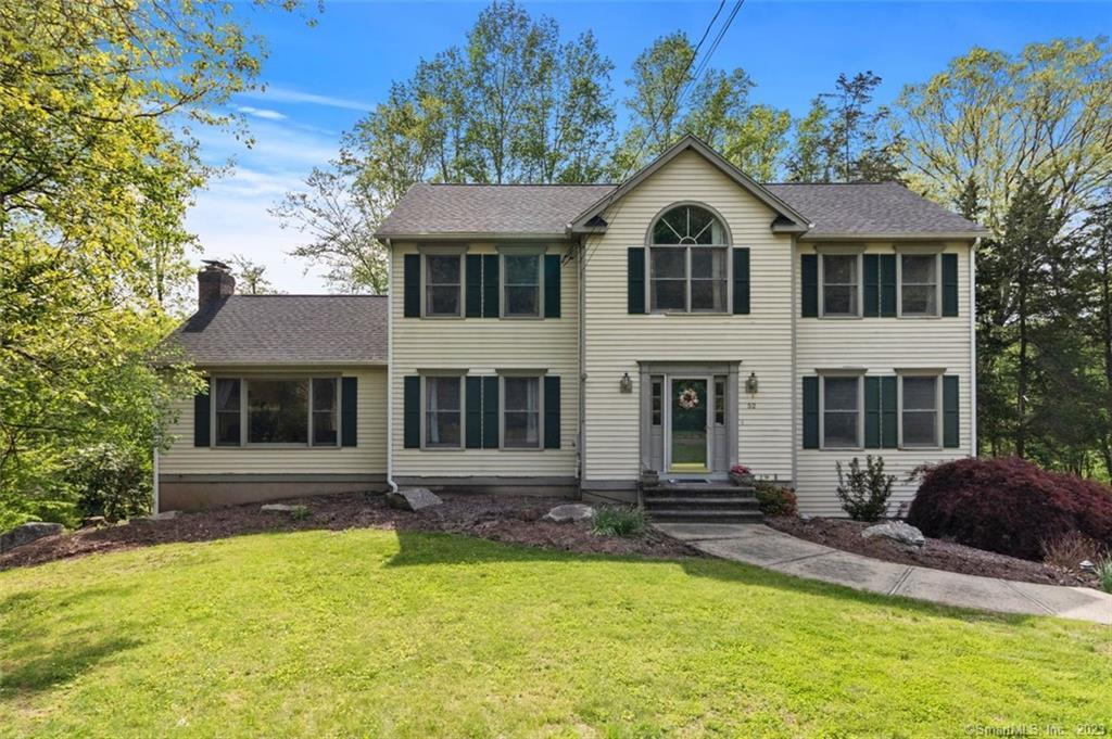 a front view of a house with yard and porch