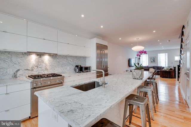 a kitchen with a stove a refrigerator and a stove top oven