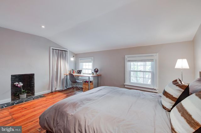 a bed room with a bed and a chair