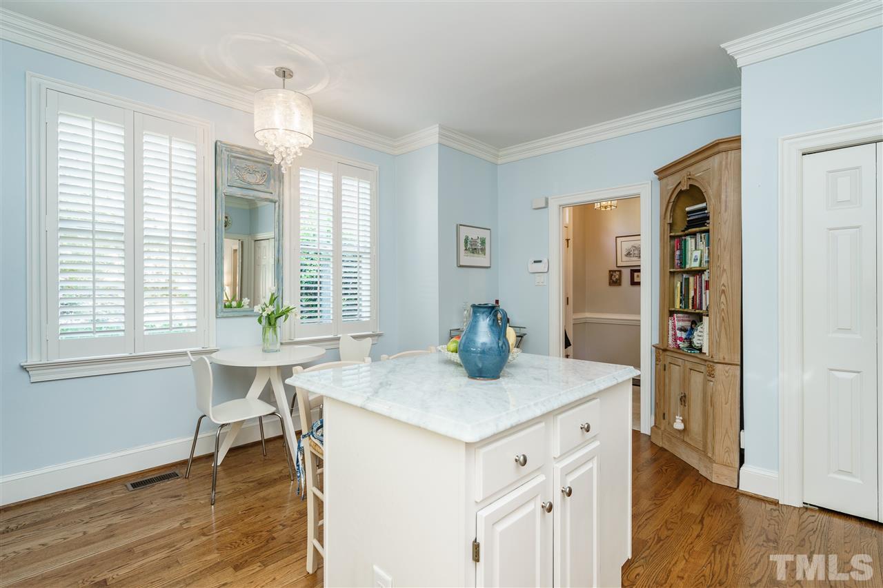 3320 Ridgecrest Court Raleigh, NC 27607 - Photo 13 of 24 a view of kitchen island wooden floor and living room