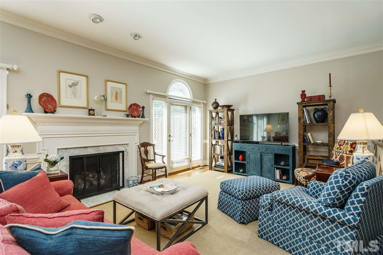 3320 Ridgecrest Court Raleigh, NC 27607 - Photo 4 of 24 a living room with furniture a fireplace and a flat screen tv