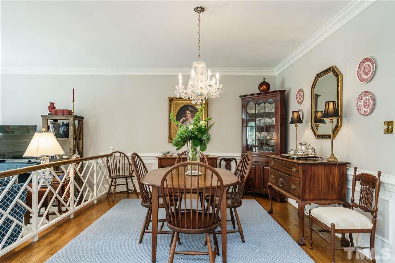 3320 Ridgecrest Court Raleigh, NC 27607 - Photo 8 of 24 a view of a dining room with furniture a chandelier and wooden floor