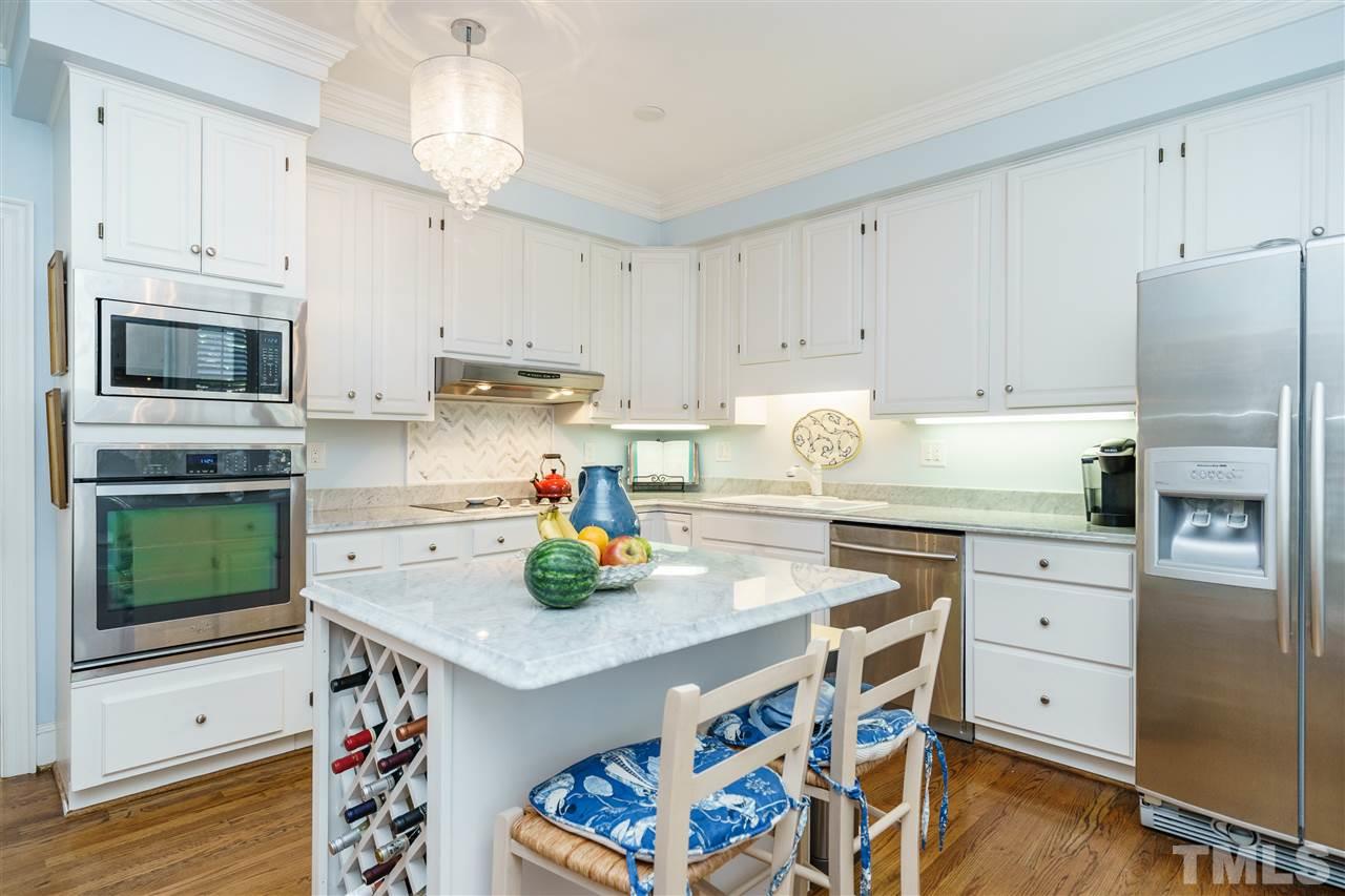 3320 Ridgecrest Court Raleigh, NC 27607 - Photo 10 of 24 a kitchen with a white stove top oven and white cabinets