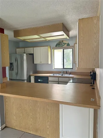 a view of a kitchen with a sink and a large window