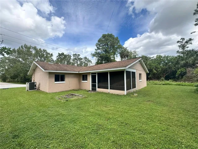 a view of a house with yard and sitting area