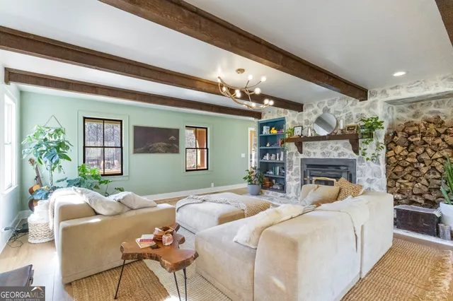 a living room with furniture a fireplace and a potted plant