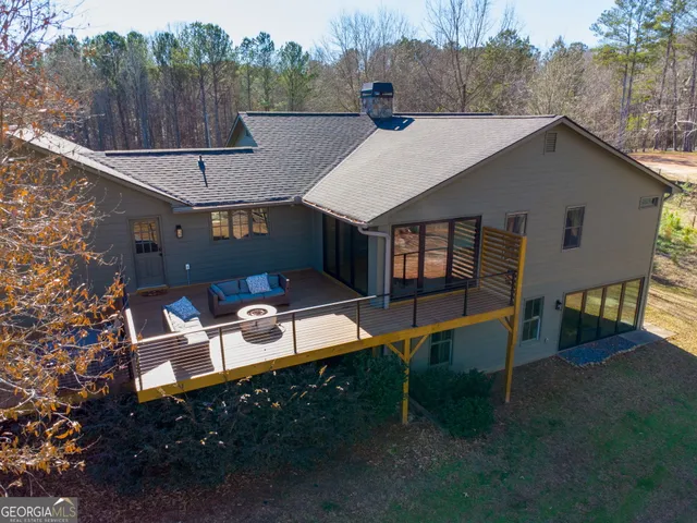 a view of a house with pool and chairs