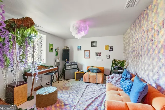 a bedroom with a bed and a painting on the wall