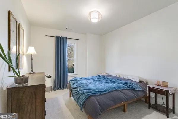 a bedroom with furniture and a wooden floor