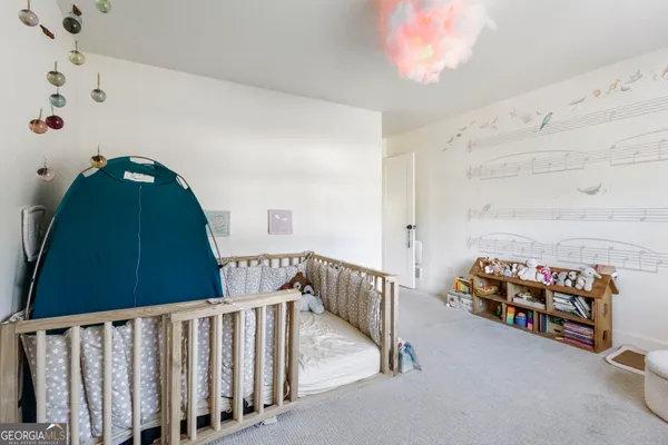 a bedroom with furniture and a baby crib