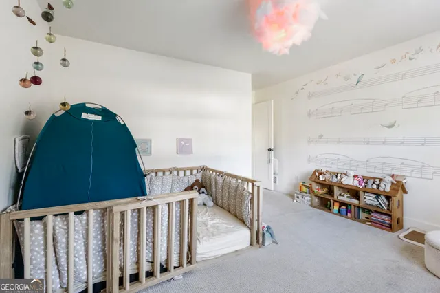 a bedroom with furniture and a baby crib