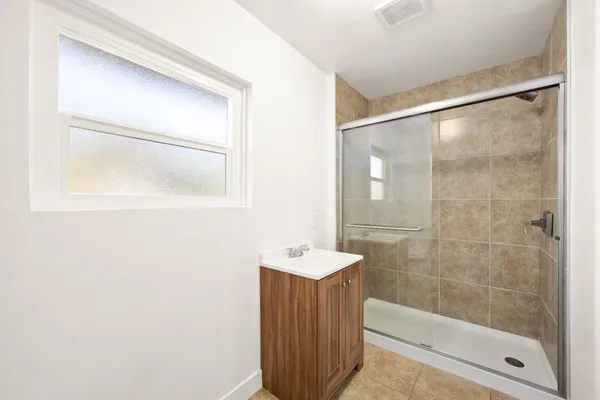 a bathroom with a shower and a sink