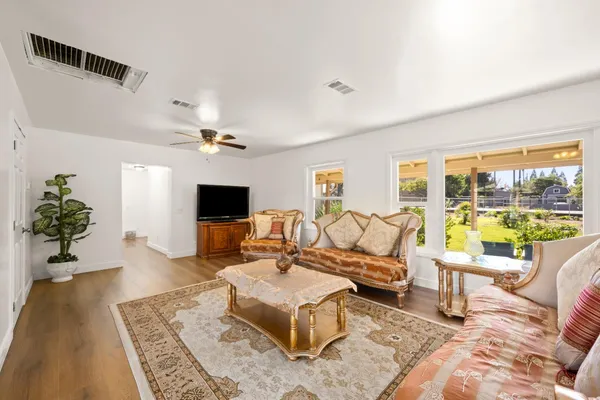 a living room with furniture large window and a flat screen tv