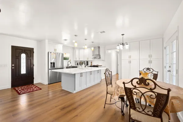 a view of a dining room with furniture and wooden floor