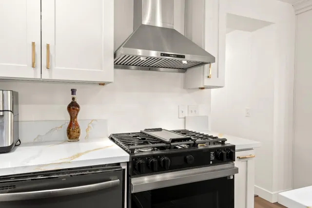 a stove top oven sitting inside of a kitchen