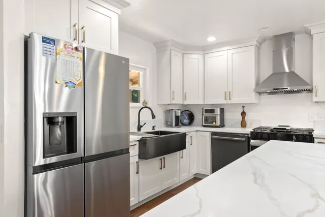 a kitchen with stainless steel appliances a refrigerator sink and cabinets