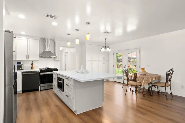 a large kitchen with lots of counter space a sink and appliances