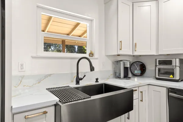 a kitchen with stainless steel appliances a sink a stove and a microwave