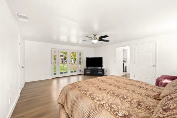 a bedroom with a bed and a flat screen tv