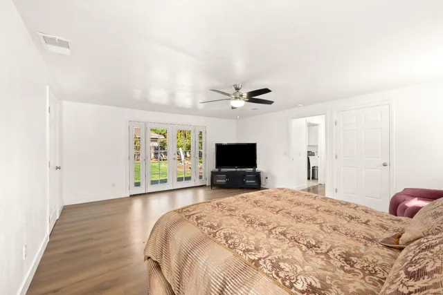 a bedroom with a bed and a flat screen tv