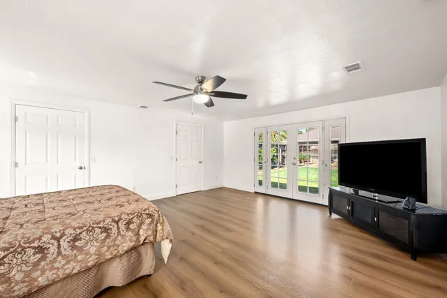 a view of a livingroom with wooden floor and a flat screen tv