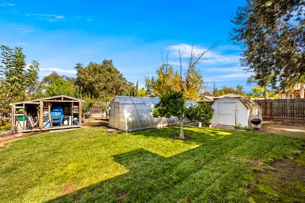 a view of a house with a yard and sitting area