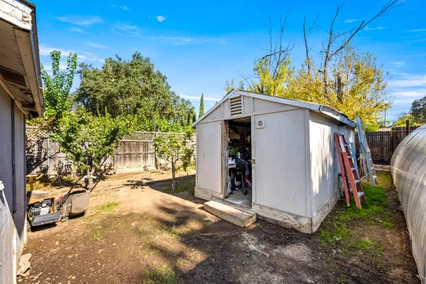 a view of a white house with a yard