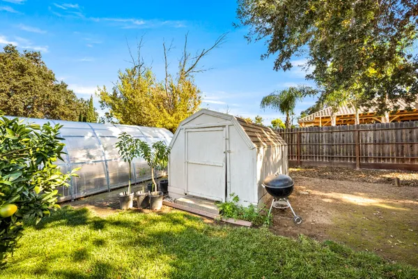 a view of backyard with wooden fence