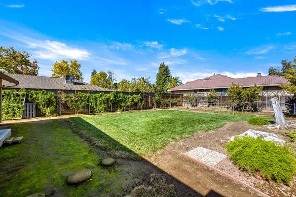 a view of a garden with a building in the background
