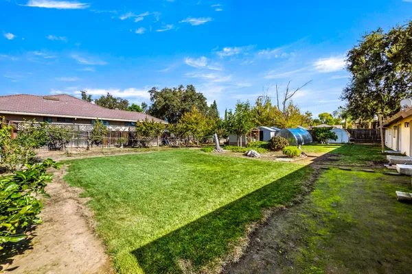 a view of yard with swimming pool and green space