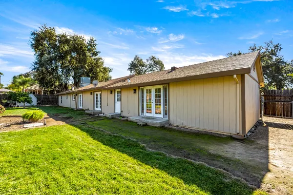 a view of a house with backyard and sitting area