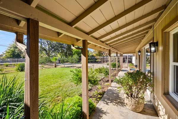 a view of a porch with chairs and floor