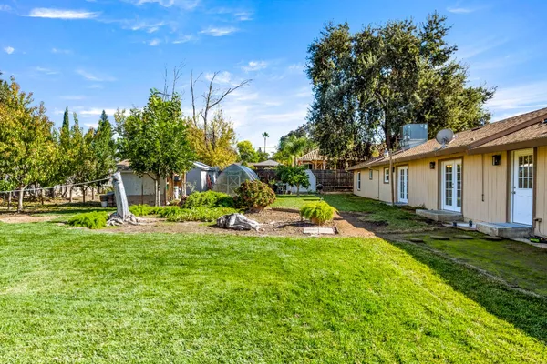 a view of a house with backyard and sitting area