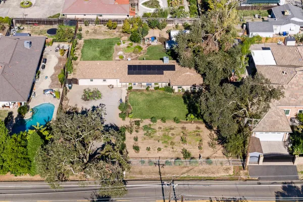 an aerial view of residential houses with outdoor space