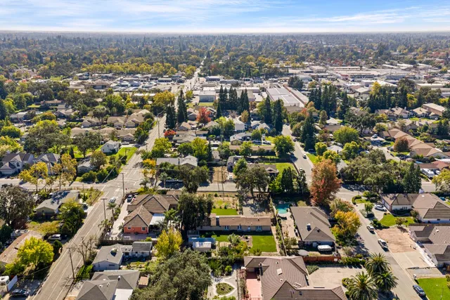 an aerial view of a residential apartment building with a yard and plants