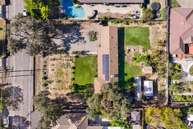 a view of a large house with a big yard and large trees