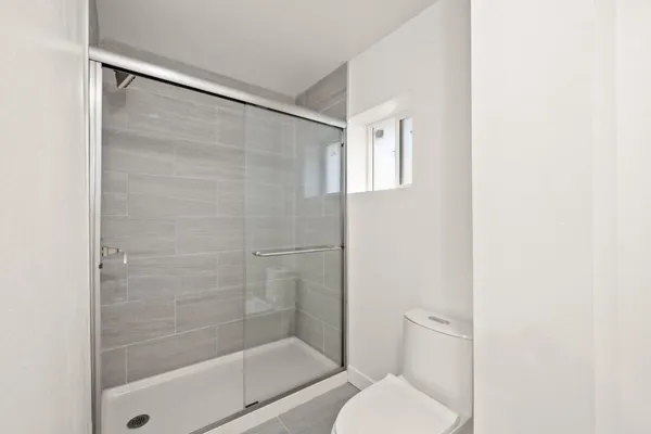 a bathroom with a shower and toilet