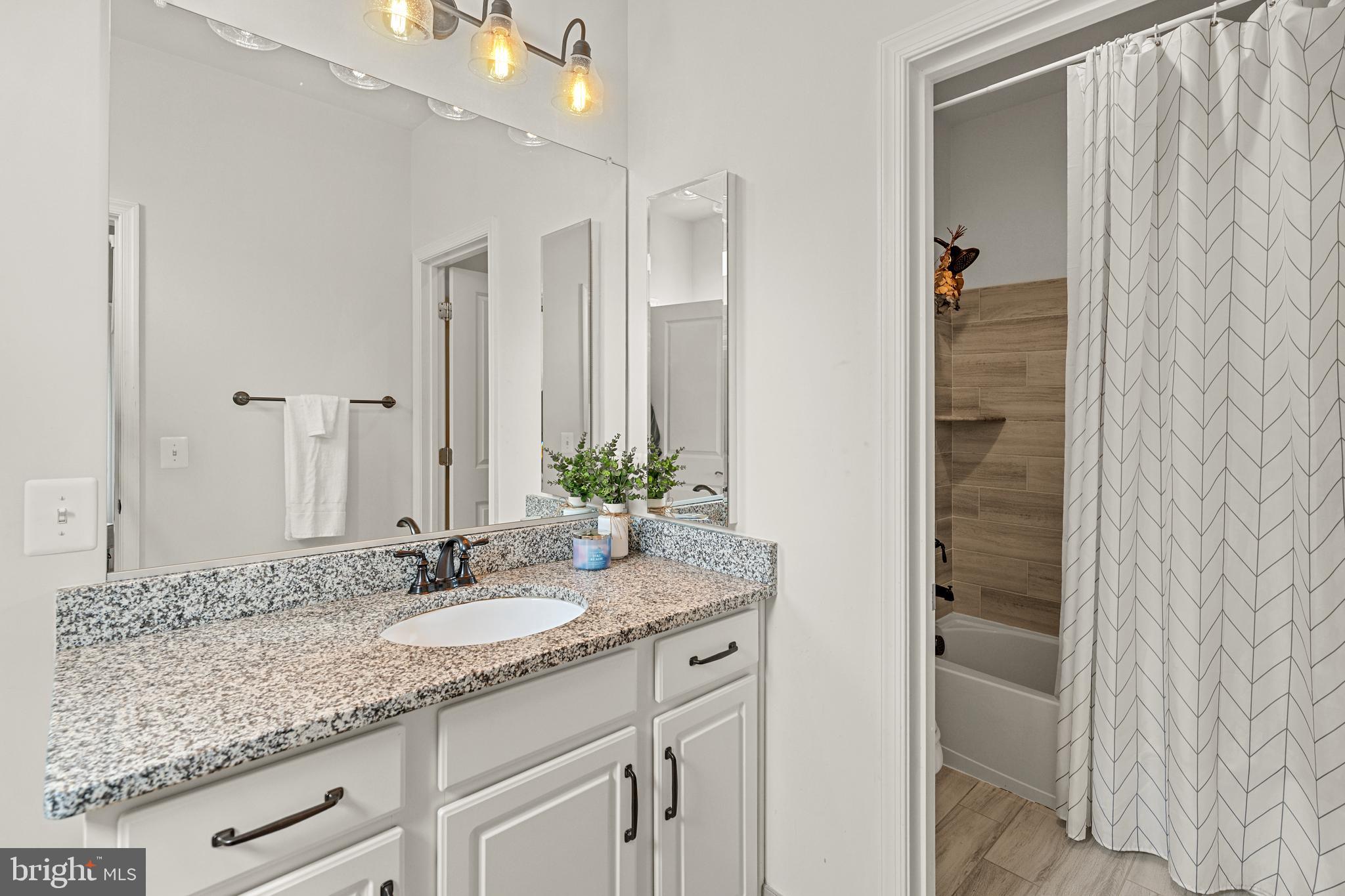 8459 Reformatory Way Lorton, VA 22079 - Photo 37 of 78 a bathroom with a granite countertop sink and a mirror