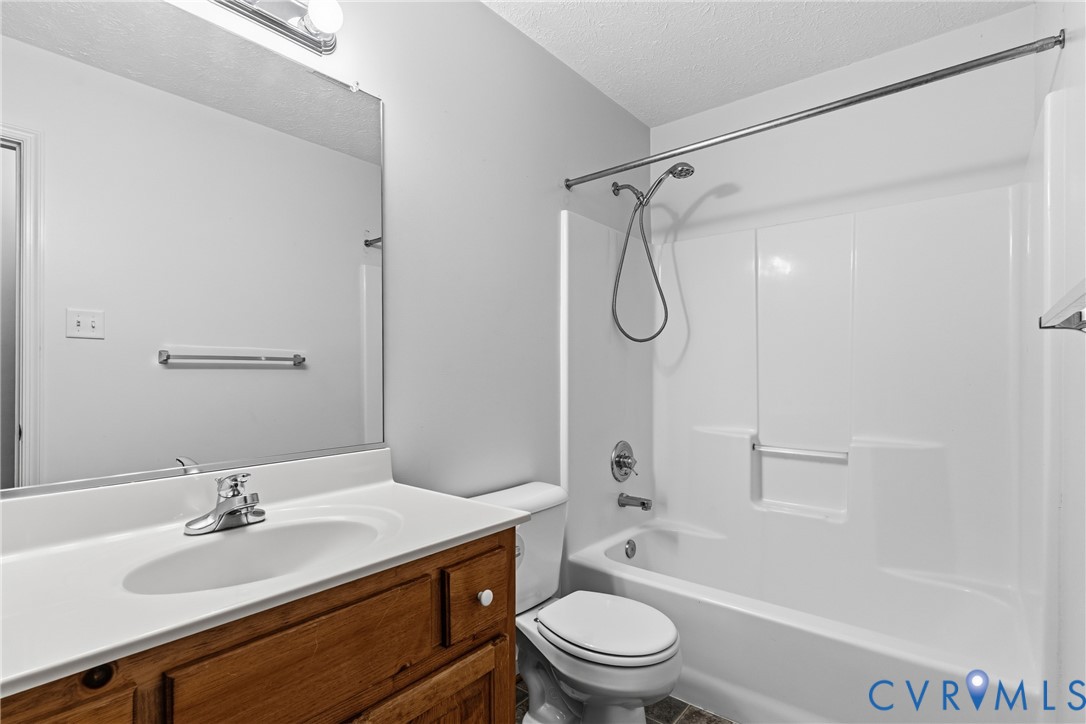 12654 Mt Olive Cohoke Road West Point, VA 23181 - Photo 20 of 31 a bathroom with a granite countertop sink a toilet and shower