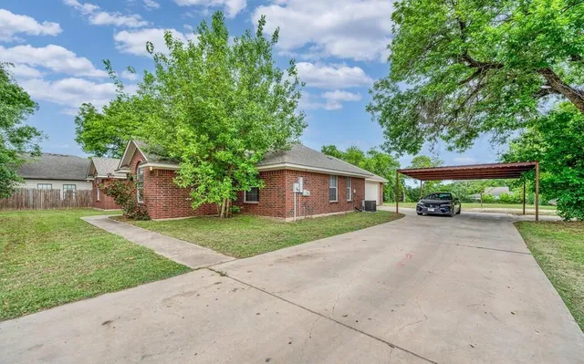 a front view of a house with a yard and a garage
