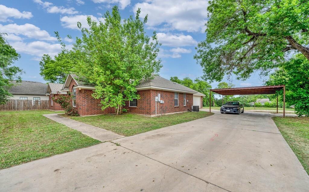 2618 South 2nd Street Waco, TX 76706 - Photo 3 of 40 a front view of a house with a yard and a garage