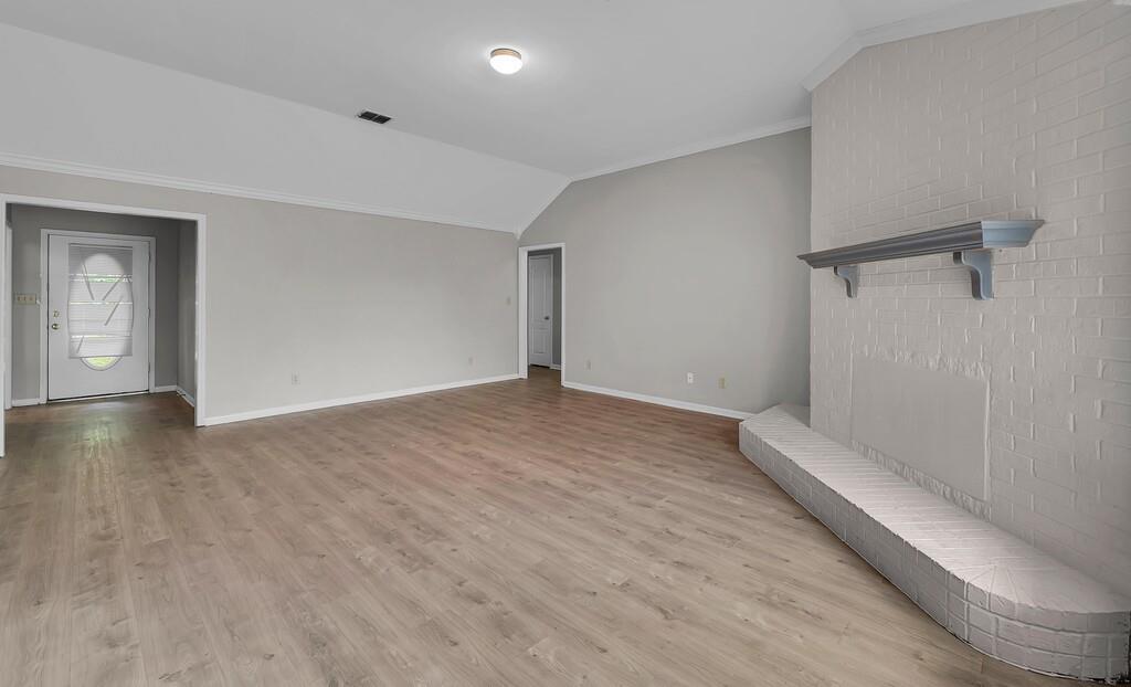 2618 South 2nd Street Waco, TX 76706 - Photo 7 of 40 an empty room with wooden floor and windows