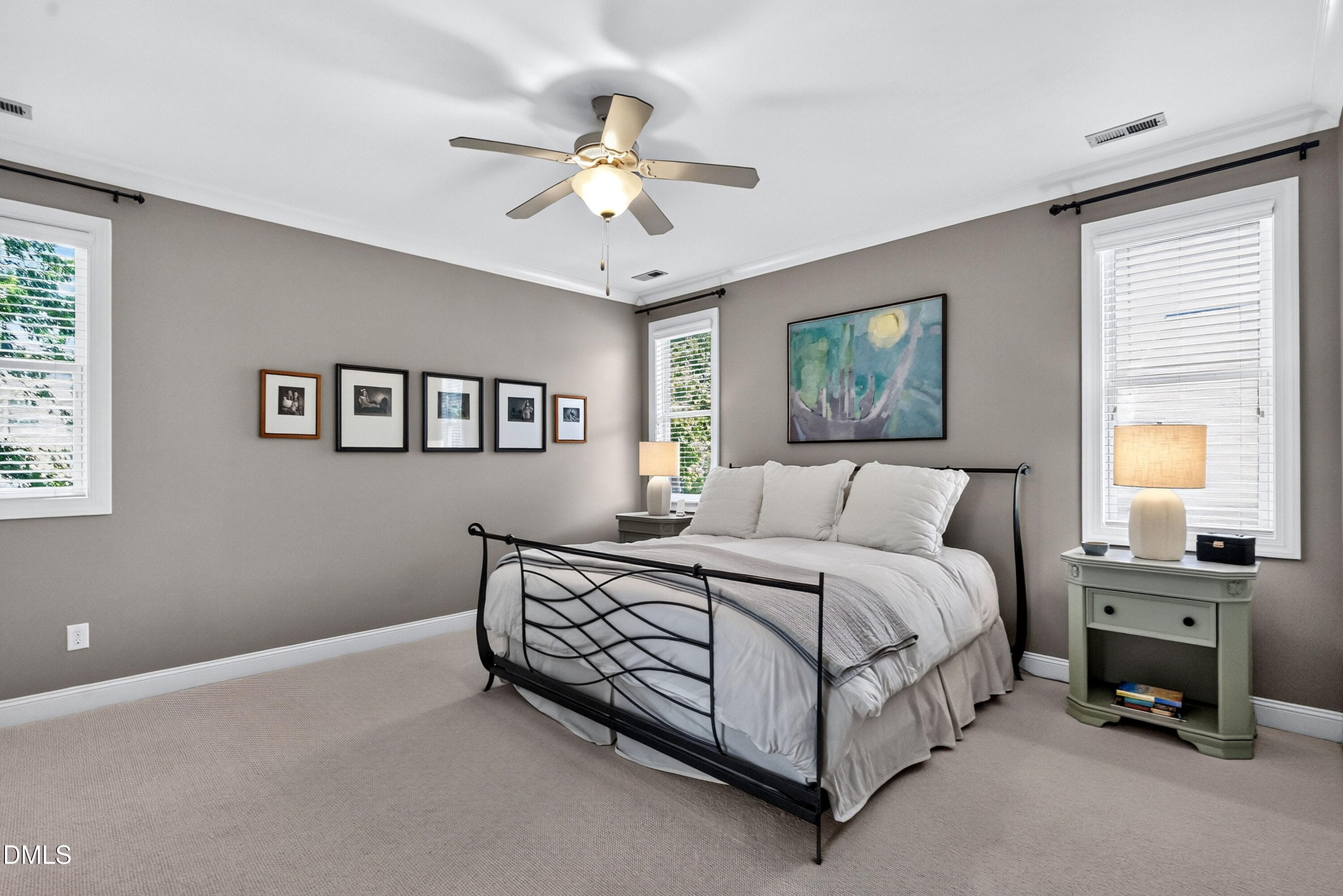2745 Oberlin Road, Unit 103 Raleigh, NC 27608 - Photo 6 of 23 a spacious bedroom with a bed a couch and a chandelier