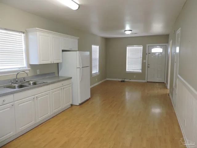 a view of a kitchen with a sink cabinets and a window