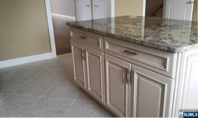 a kitchen with a granite countertop cabinets and sink