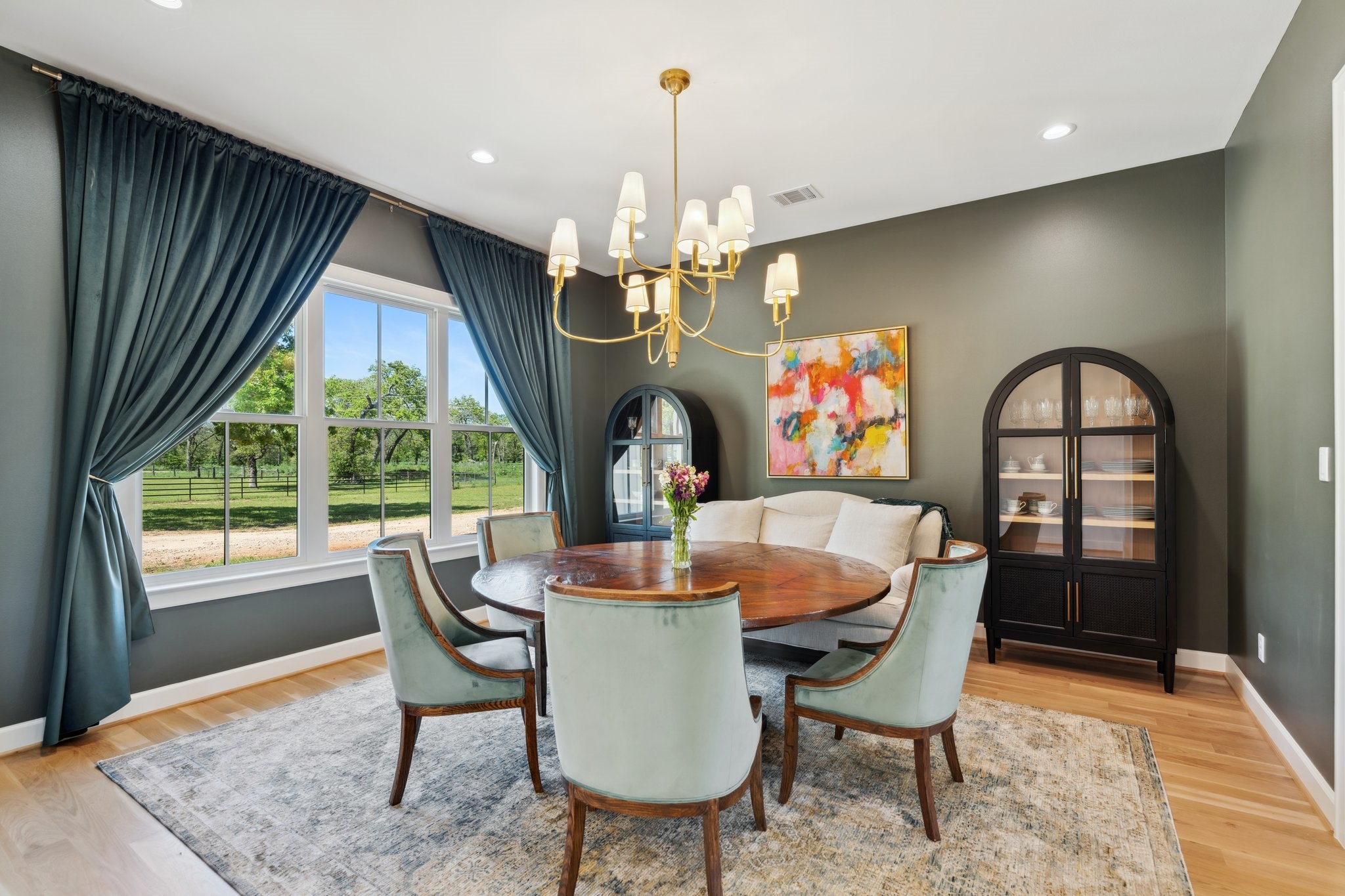 4052 Kuykendall Road Bellville, TX 77418 - Photo 4 of 40 Step into this charming home and be welcomed by an elegant dining room with expansive windows, offering a delightful view of the lush front property.