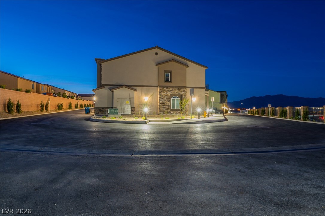 6444 Spring Jog Street Las Vegas, NV 89166 - Photo 2 of 13 This modern home features a striking facade and inviting exterior lighting.